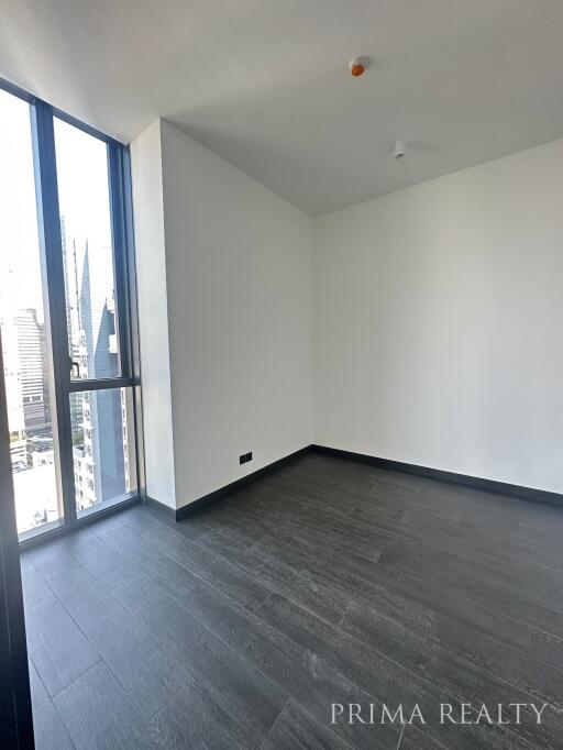 Empty bedroom interior with large window and city view