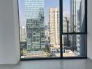 Modern bedroom with large window overlooking the city skyline