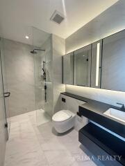 Modern bathroom with marble tiles and glass shower enclosure