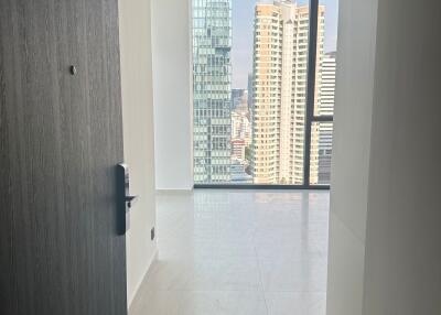 View into an apartment interior showcasing the cityscape through large windows