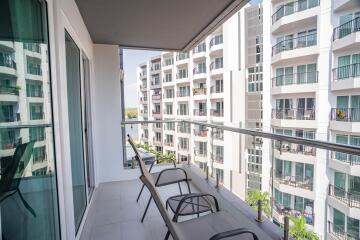 Spacious balcony with seating and a view of the apartment complex