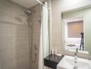 Modern bathroom with walk-in shower, neutral tile, and clean design