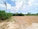 Spacious empty land with clear skies and potential for development