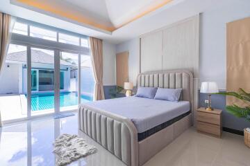 Modern bedroom with pool view through large window