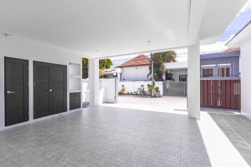 Spacious well-lit garage with multiple doors and a clean driveway
