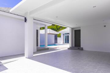 Spacious covered patio area with swimming pool view and tiled flooring