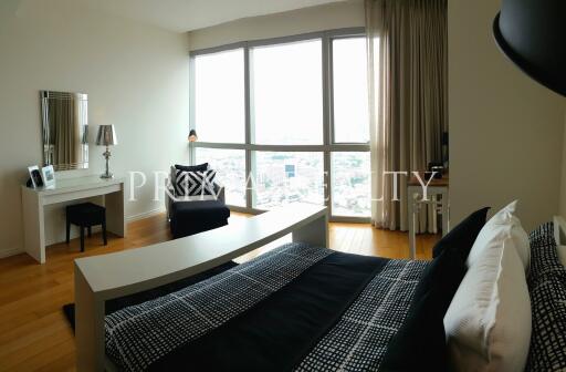 Modern bedroom with large windows and city view