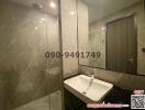 Modern bathroom with glass shower and marble walls