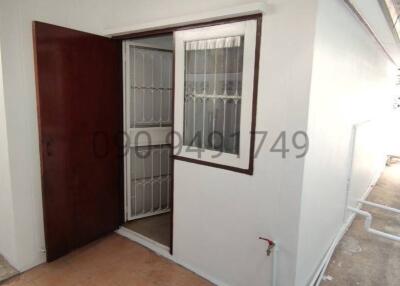 Entrance of a residential building with security door and tiled floor