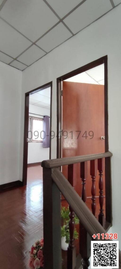 Spacious hallway with hardwood flooring and access to various rooms