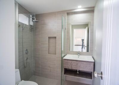 Modern bathroom with walk-in shower, vanity, and large mirror