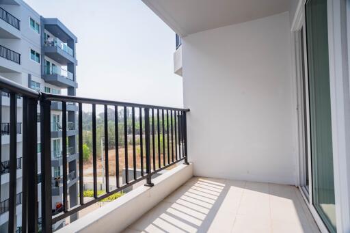 Spacious balcony with a view, featuring modern railings and ample natural light