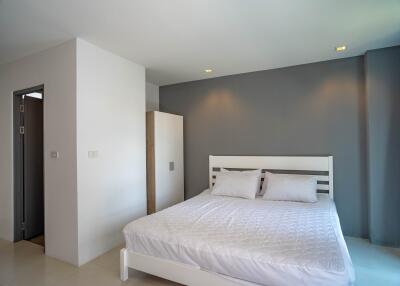 Modern bedroom interior with white bed and gray curtains