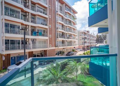 Exterior view of a modern apartment building with balconies and glass railings