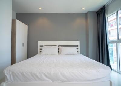 Modern bedroom with a large bed and natural light