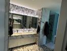 Modern bathroom with marble finish and mirrored cabinets