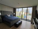 Spacious bedroom with large windows and city view