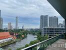 City view from the balcony of an apartment with river and skyline