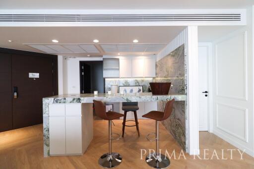 Modern kitchen with bar seating and wood flooring