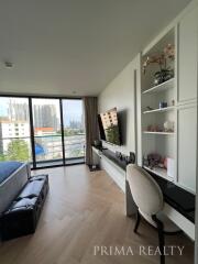 Well-lit bedroom with modern furniture and city view