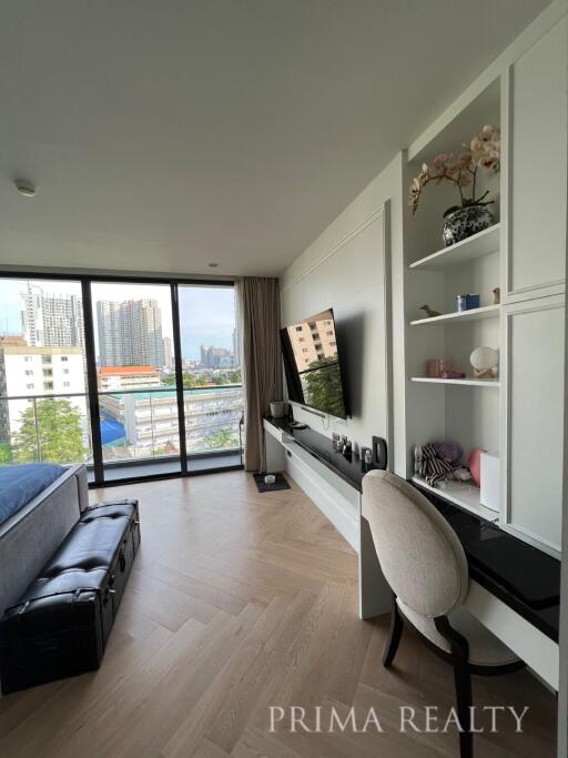 Well-lit bedroom with modern furniture and city view