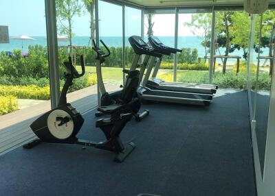 Home gym with exercise equipment and ocean view