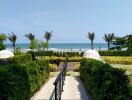 Oceanfront property view with garden and path leading to the beach