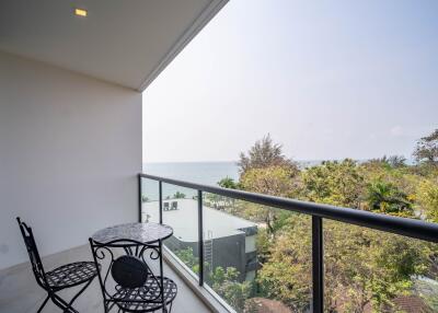 Spacious balcony with ocean view and outdoor seating