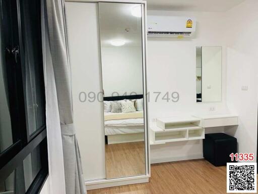 Modern bedroom with mirrored wardrobe and study area