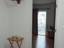 Cozy bedroom interior with wooden flooring and open doorway