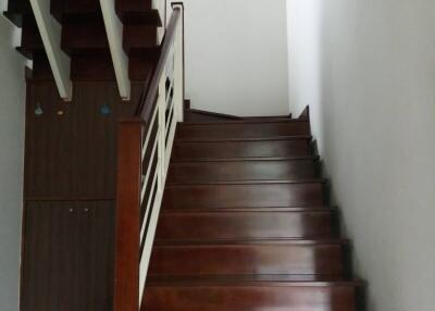 Wooden staircase with white walls in a modern home