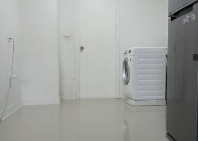 Interior of a building space with washing machine and air conditioning unit