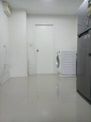 Interior of a building space with washing machine and air conditioning unit
