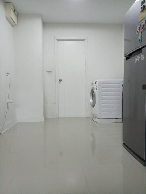 Interior of a building space with washing machine and air conditioning unit