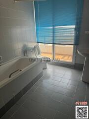 Spacious bathroom with natural light and modern fixtures