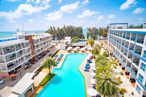 Aerial view of a resort with a swimming pool and beach access