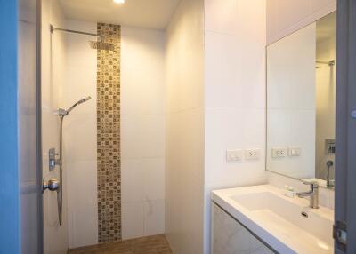 Modern bathroom with walk-in shower and white vanity