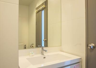 Modern clean bathroom with white vanity and large mirror