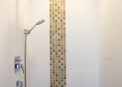 Modern bathroom with white walls and decorative tile shower