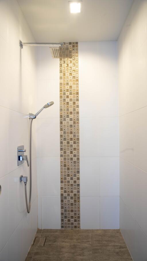 Modern bathroom with white walls and decorative tile shower