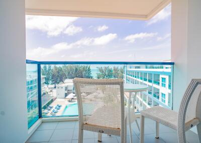 Bright and airy balcony with a view of the ocean and pool area