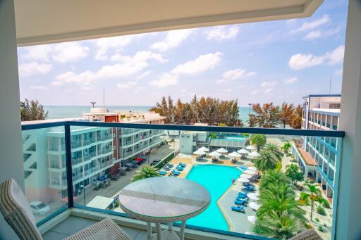 Balcony view overlooking a pool and the ocean