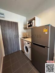 Compact kitchen with modern appliances and grey tiling