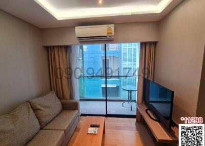 Modern living room with ample natural light and balcony access