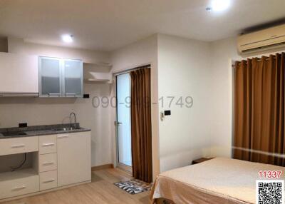 Compact studio apartment with integrated kitchen and sleeping area
