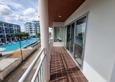 Spacious balcony with pool view in a modern residential complex