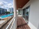 Spacious balcony with pool view in a modern residential complex