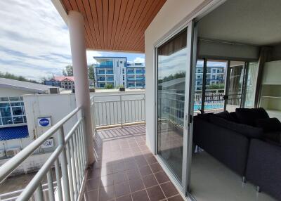 Spacious balcony with outdoor seating and view of surrounding area