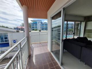 Spacious balcony with outdoor seating and view of surrounding area
