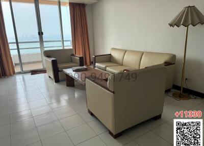 Spacious living room with ocean view and ample natural light